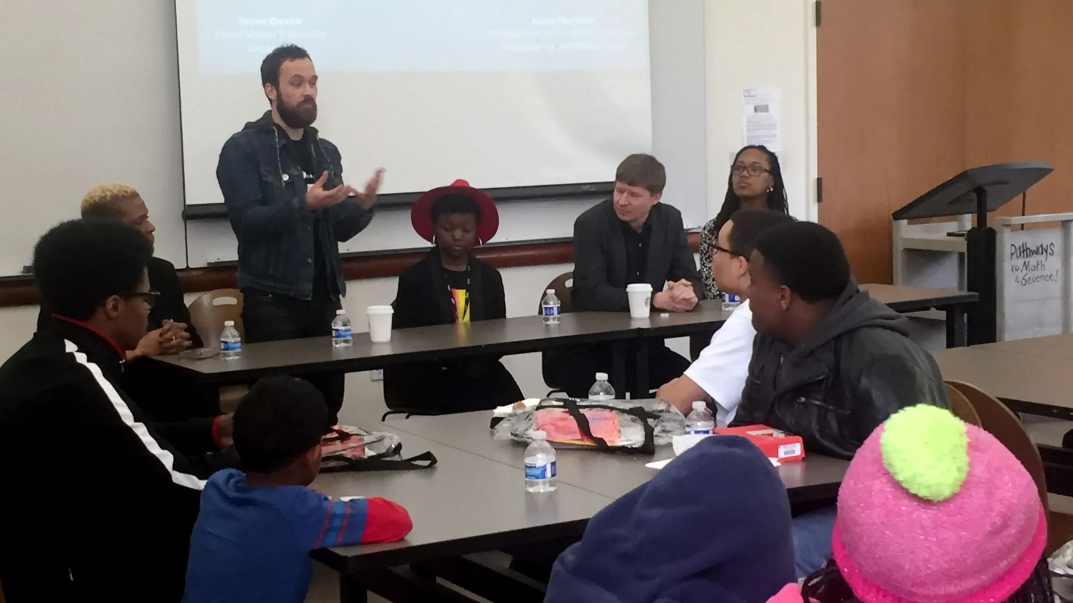 Denis teaching in front of a class